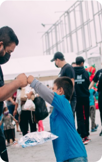 A volunteer serving a child during a community activity